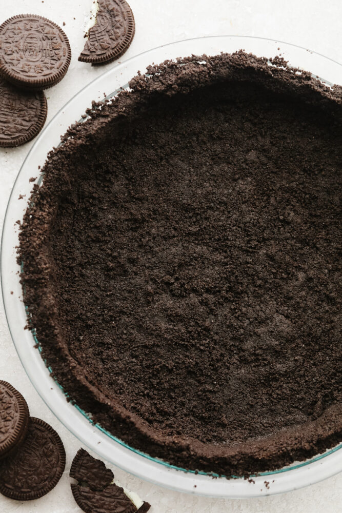 Oreo pie crust pressed into a pie pan.