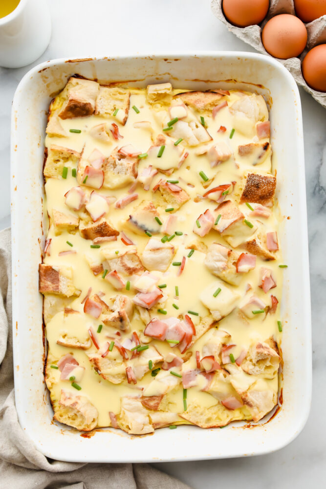 Eggs benedict casserole in a white serving dish.