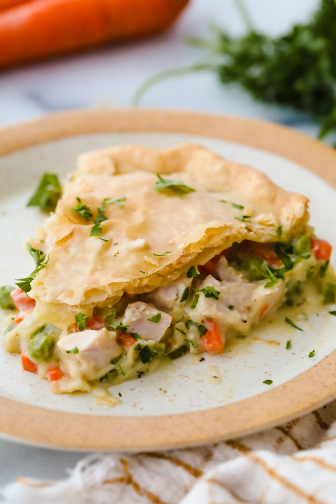 A slice of turkey pot pie on a plate. 