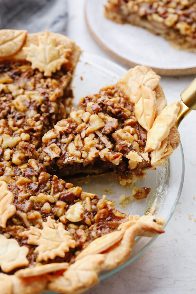 Taking a slice of walnut pie out of the pan.