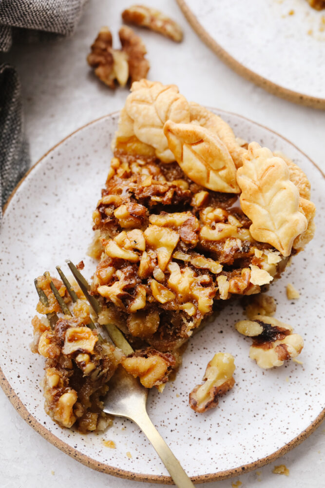 Taking a bite of a walnut pie slice.