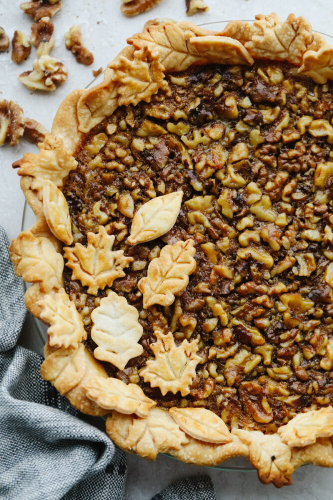 A walnut pie topped with leaf-shaped crust pieces.