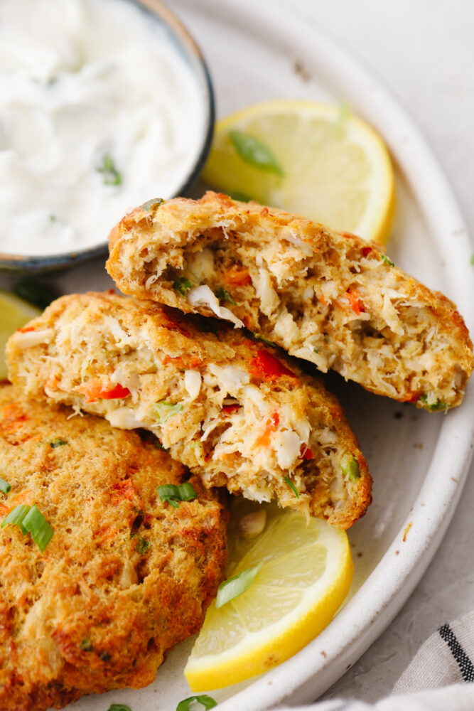 Closeup of a crab cake split in 2 pieces.