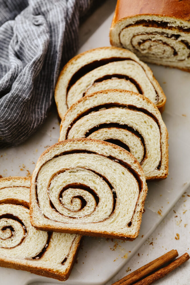 Slices of cinnamon swirl bread on a cutting board. 