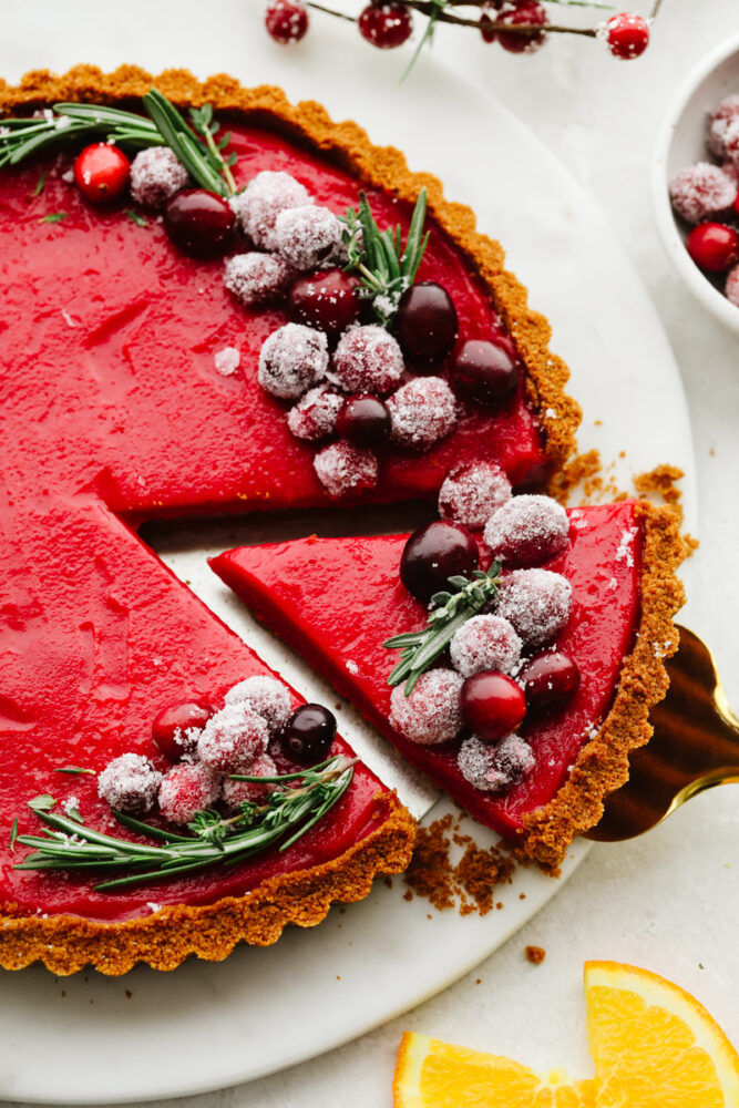 Getting a slice of cranberry curd tart with a pie spatula.