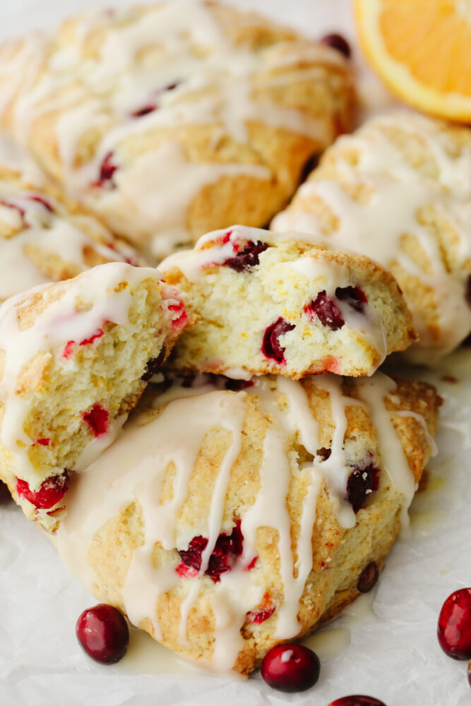 Scones that are stacked and one is broken open so you can see the inside. 