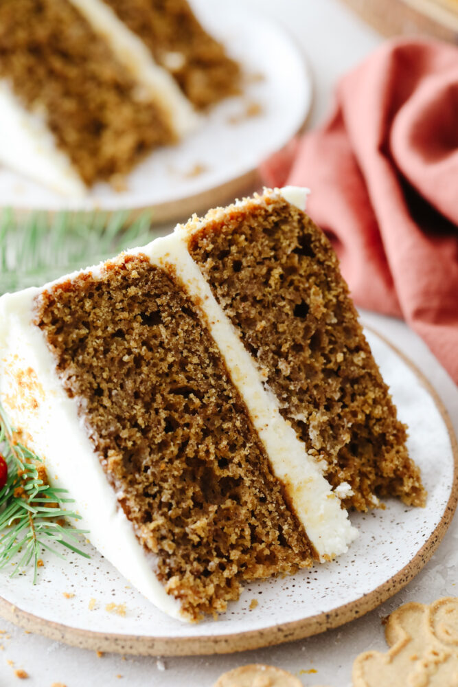 A slice of gingerbread cake on a stoneware plate.