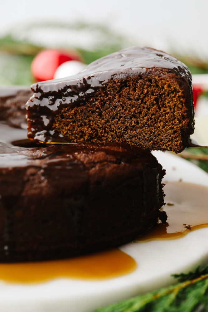 A slice of warm gingerbread cake with caramel sauce. 