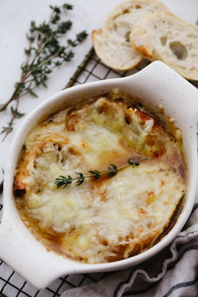 A bowl of French onion soup on a cooling rack. 