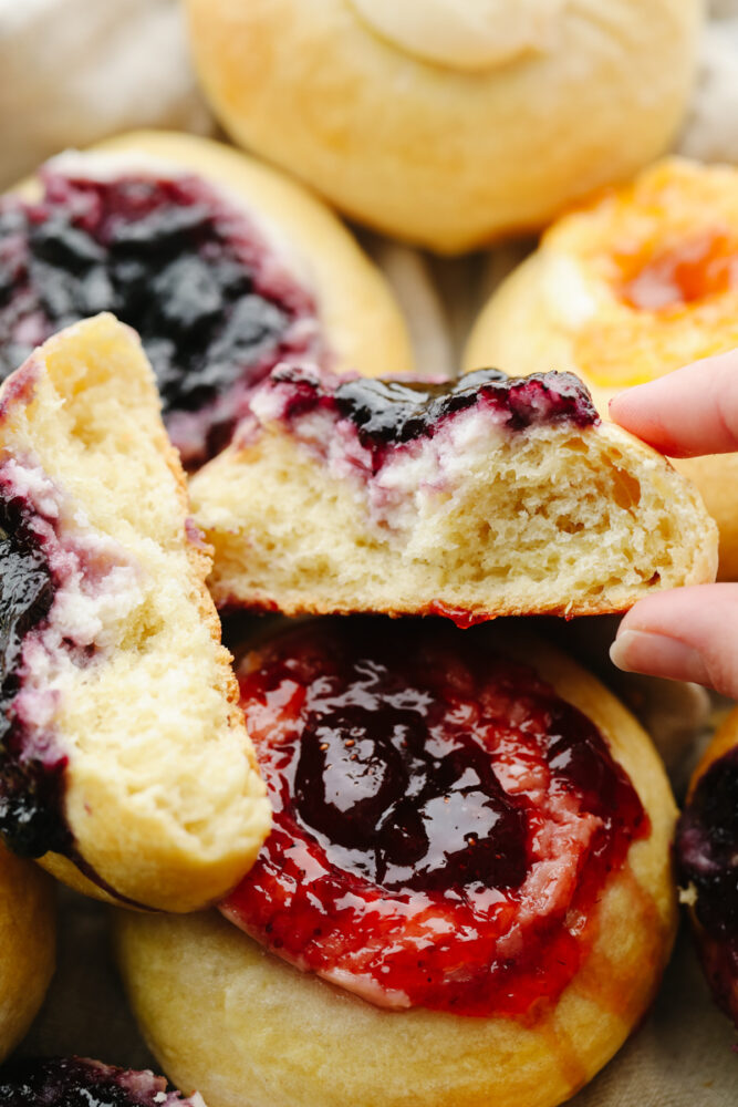 A kolache broken apart and ready to eat. 