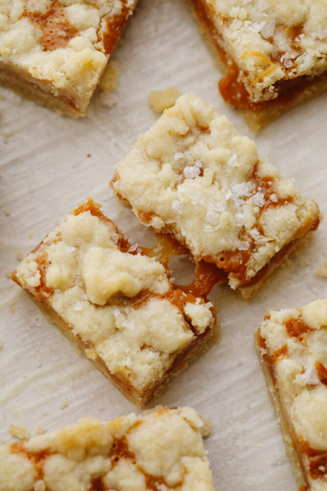 A broken salted caramel bar with caramel dripping. 