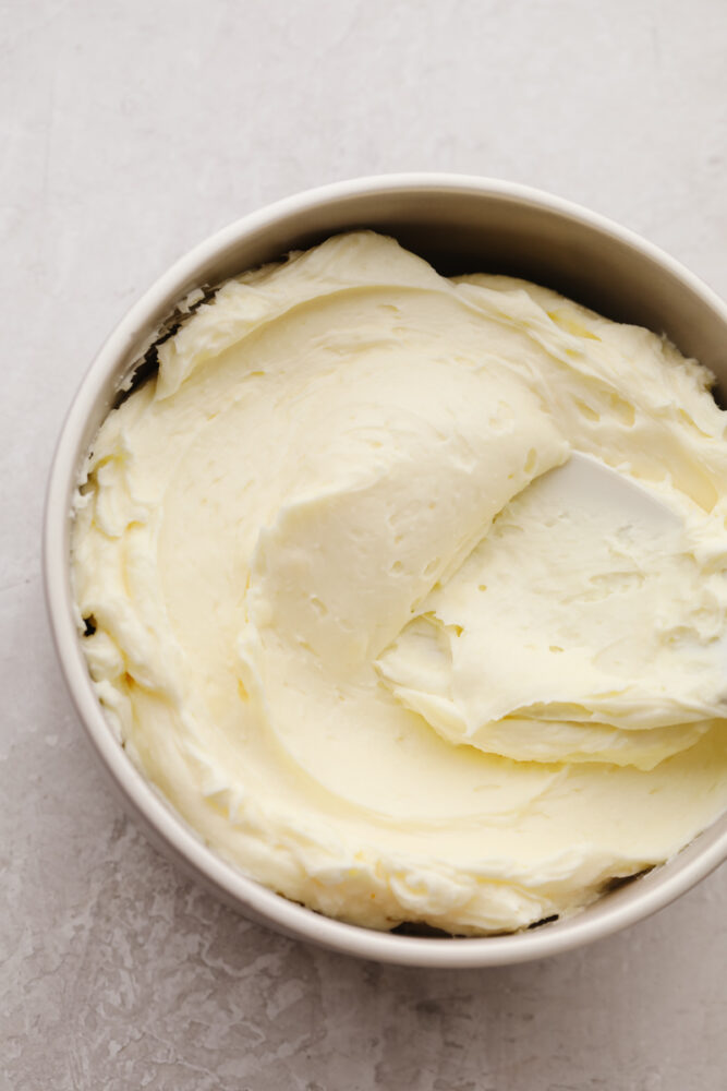 White chocolate buttercream frosting in a white bowl.