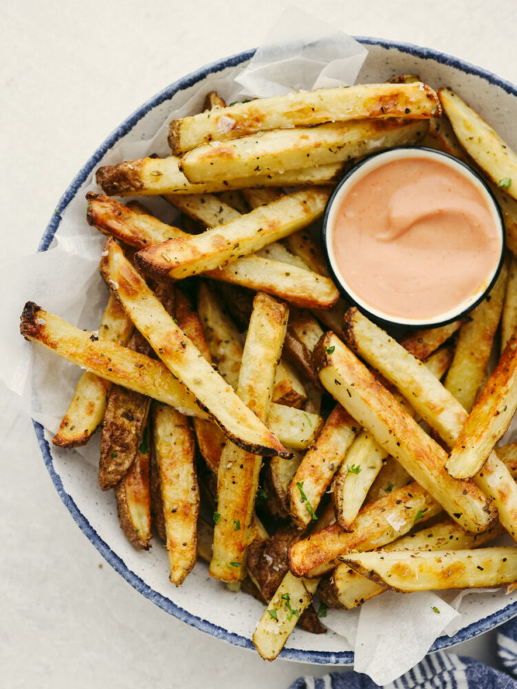 Fries on a white plate served with fry sauce.