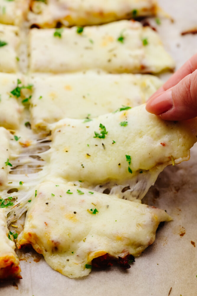 Picking up a cauliflower breadstick.