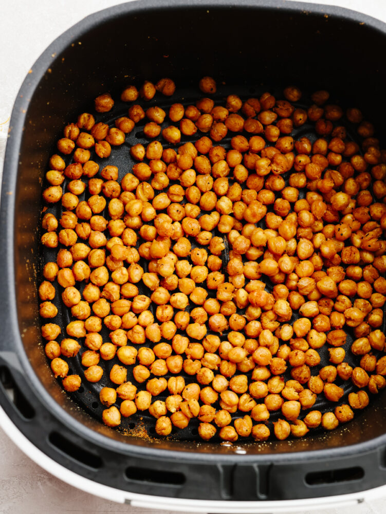 Roasted chickpeas in an air fryer basket. 