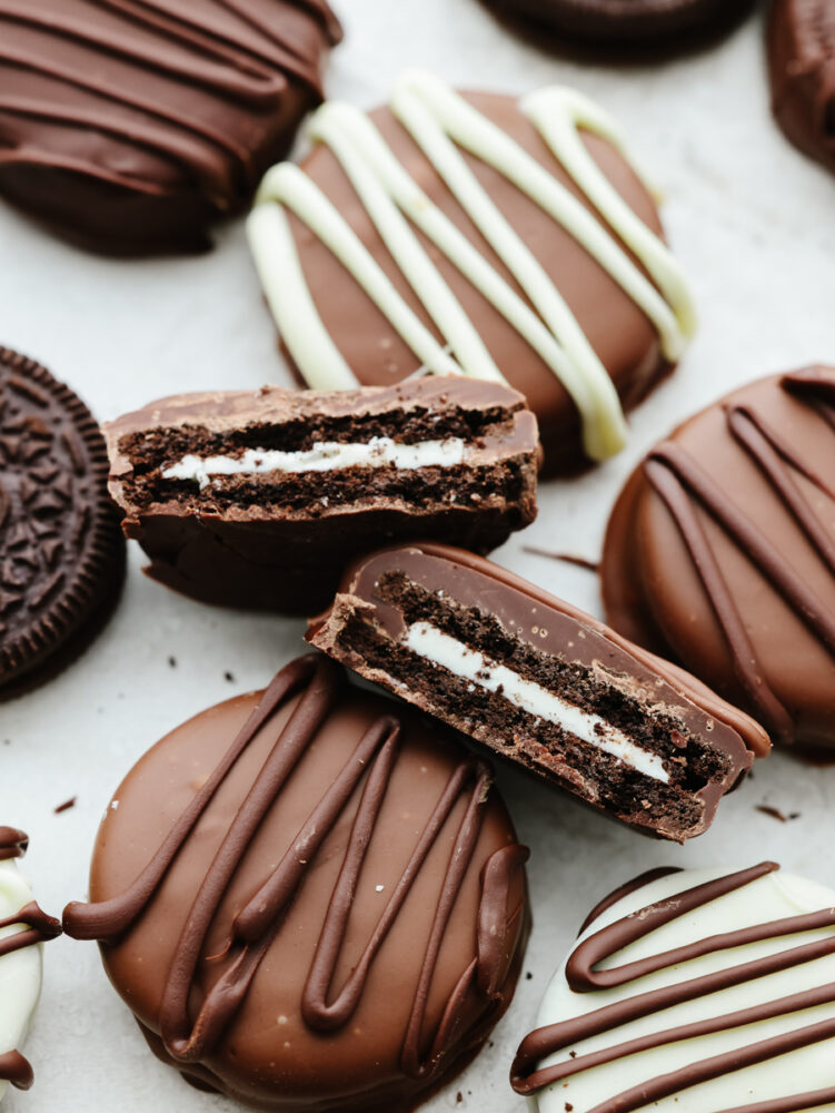 Closeup of a chocolate covered Oreo broken in half.