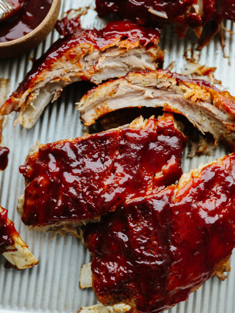 A close up of instant pot ribs with BBQ sauce on them. 