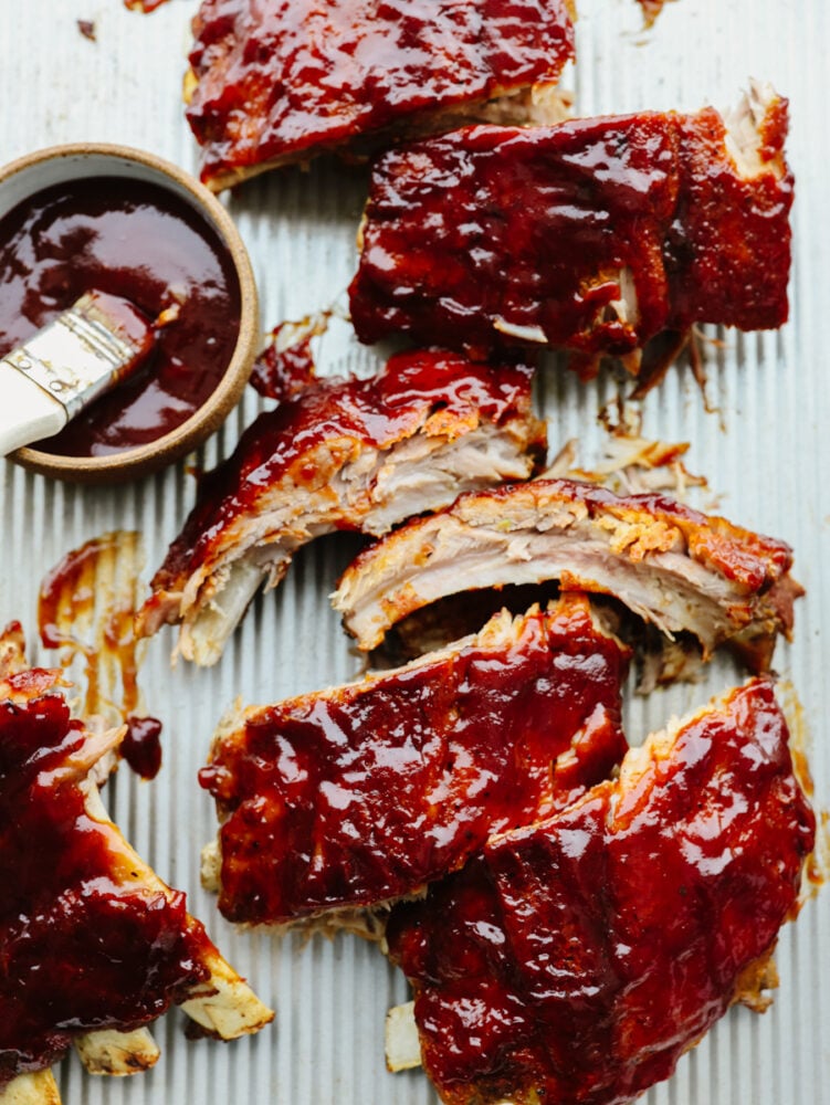 Pieces of instant pot baby back ribs with BBQ sauce on them. 