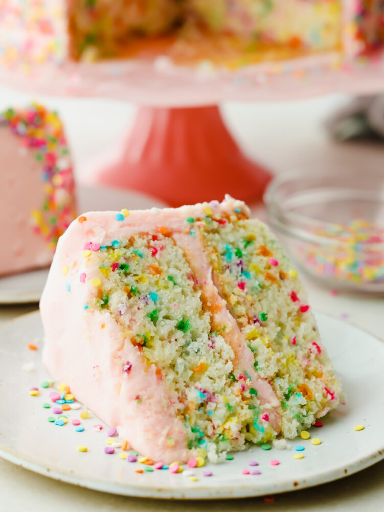 A slice of funfetti cake on a plate. 