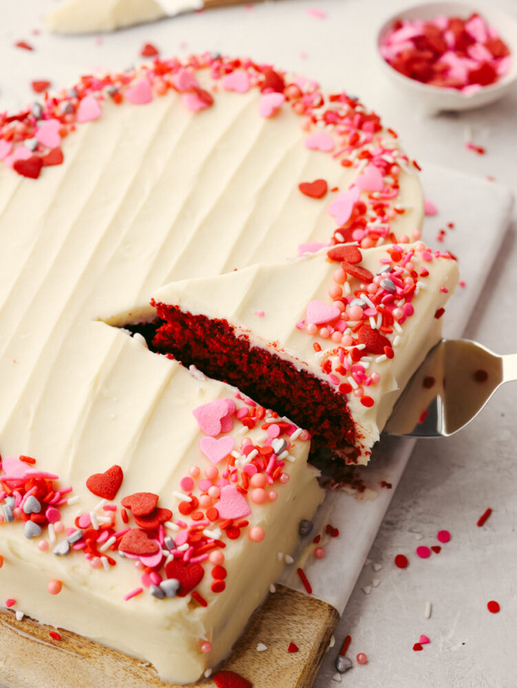 Using an icing spatula to take a slice of cake.