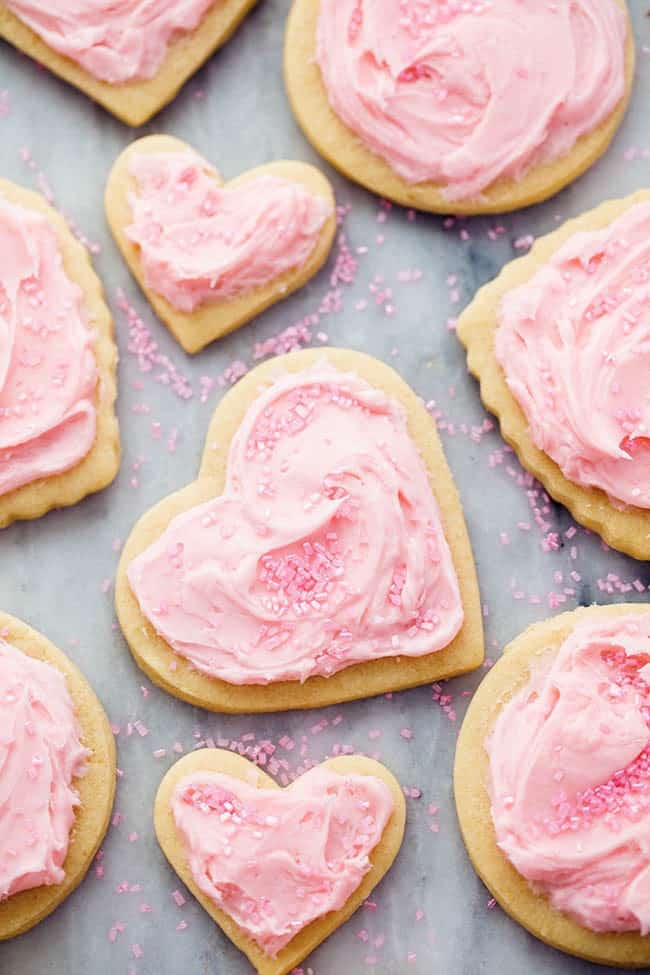 Froster sugar cookies on a baking sheet lined with parchment paper. 