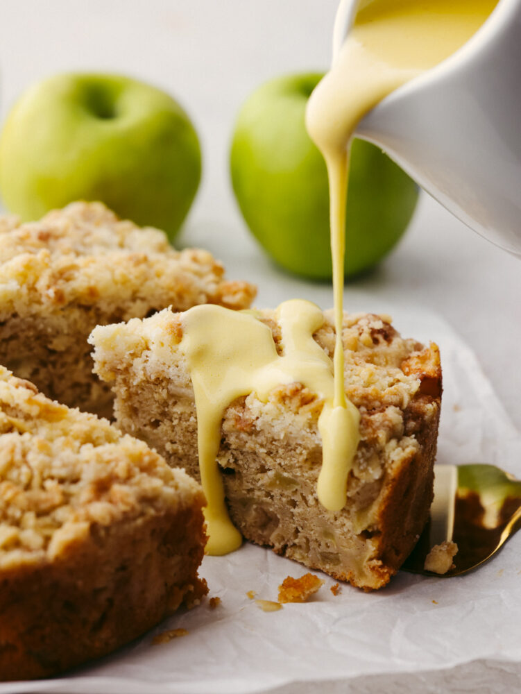 Pouring custard sauce over a slice of Irish apple cake.