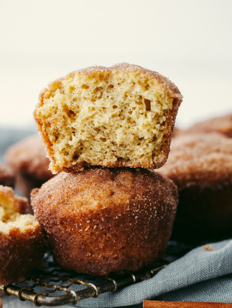 2 donut muffins stacked. The top on has a large bite taken out of it. 