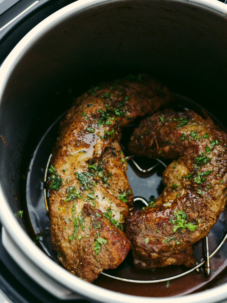 2 cuts of pork tenderloin on a trivet in an Instant Pot.