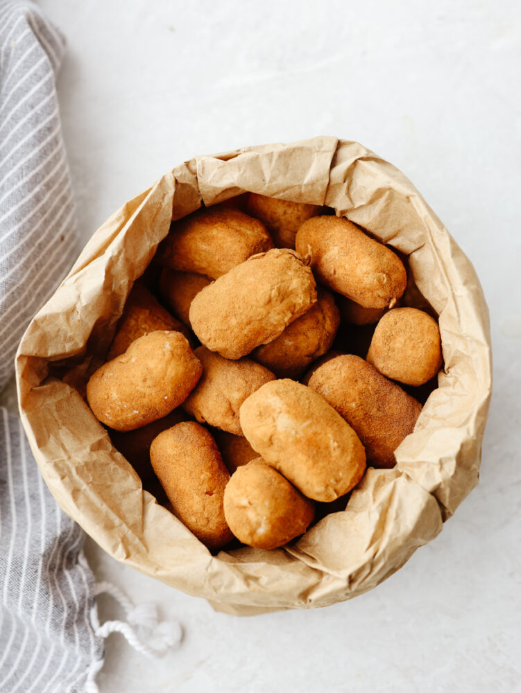 The top view of a brown paper bag filled with potato candy. 