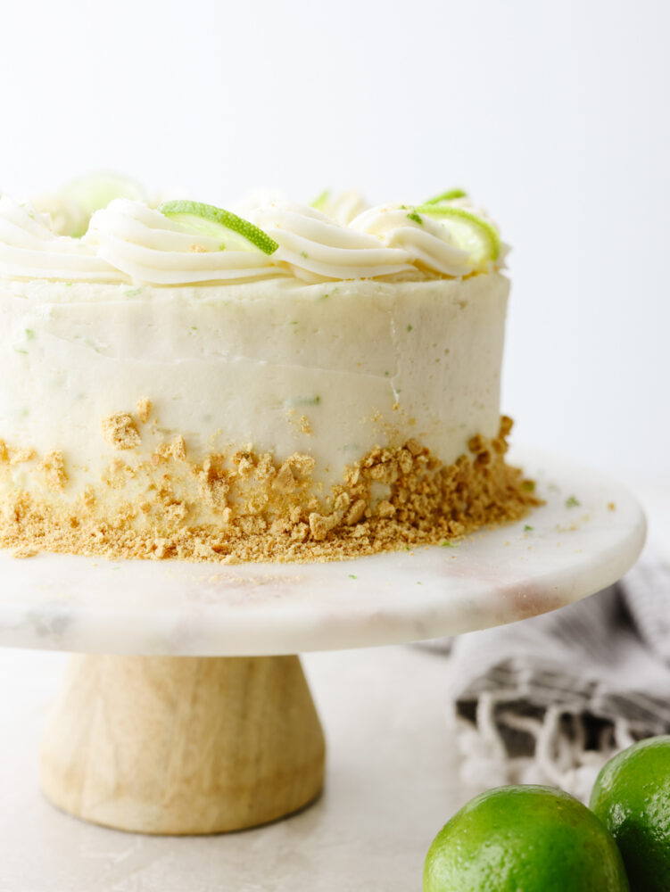 A whole key lime cake on a cake stand.