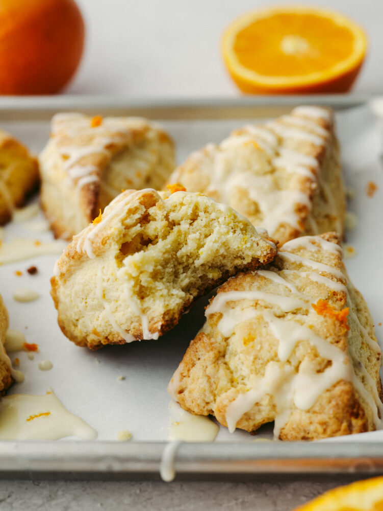 A picture of two scones stacked, the top one with a bite taken out of it. 