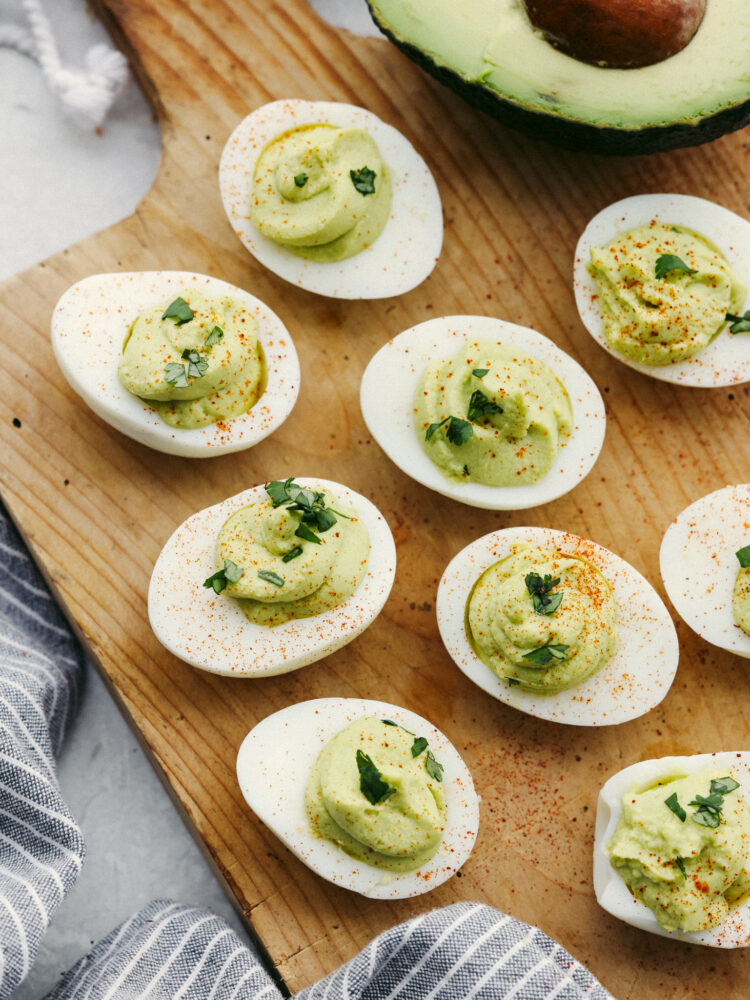 Top-down view of deviled eggs on a wooden board.