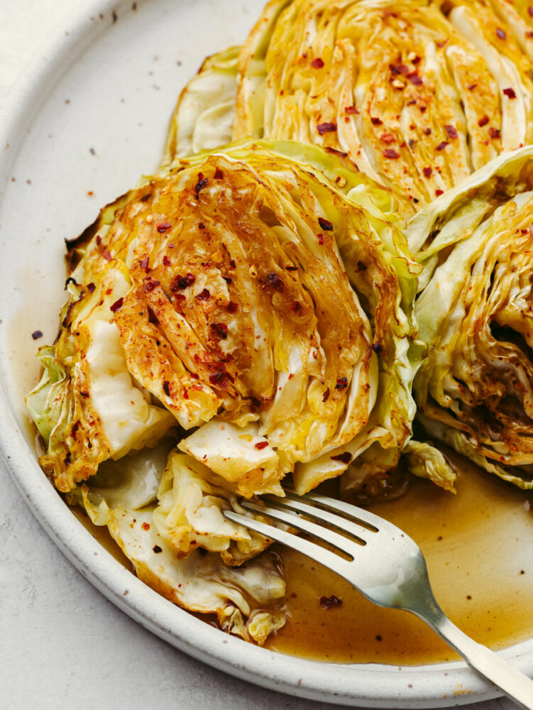 Closeup of taking a bite of cabbage with a fork.