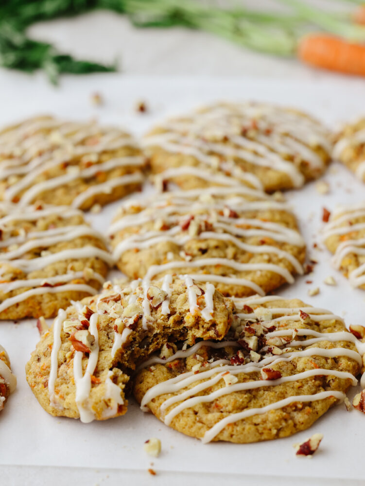 Closeup of a carrot cake cookie with a bite taken out of it.