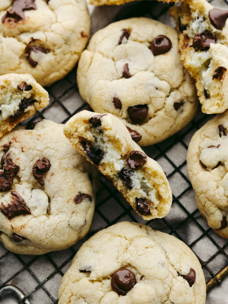 Closeup of a cheesecake stuffed chocolate chip cookie broken in half.