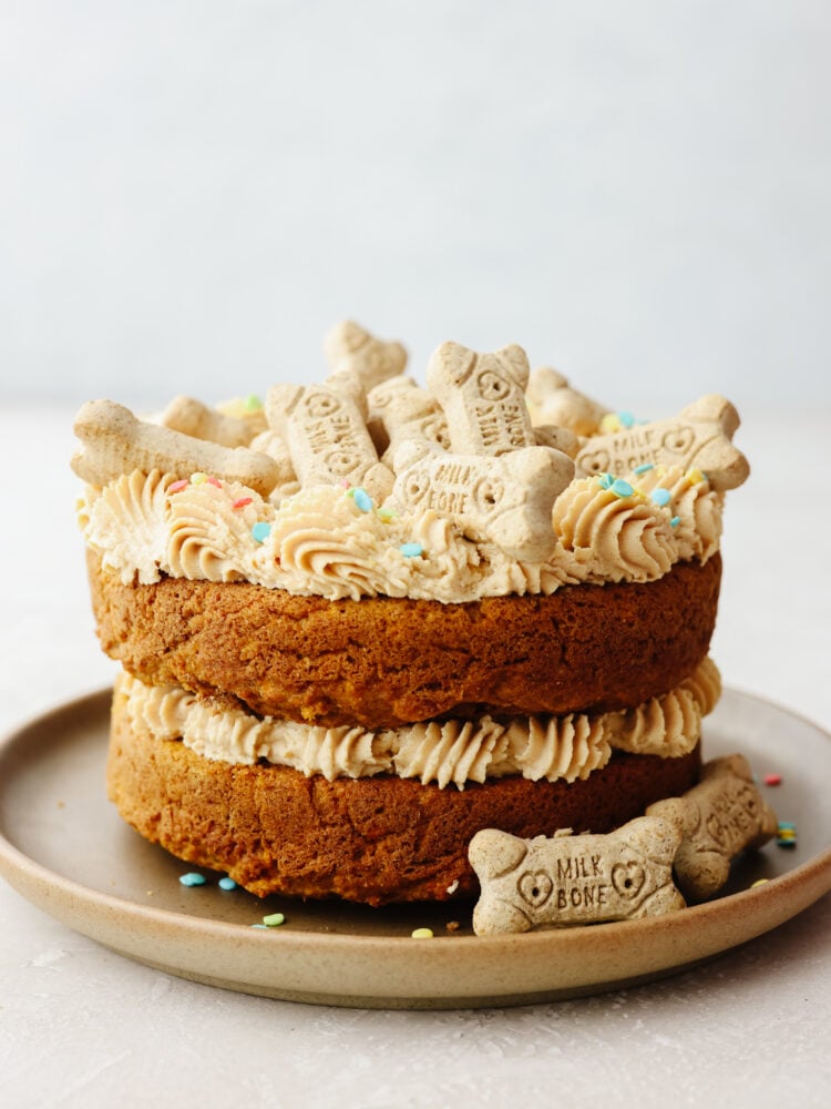 A whole dog birthday cake topped with dog treats.