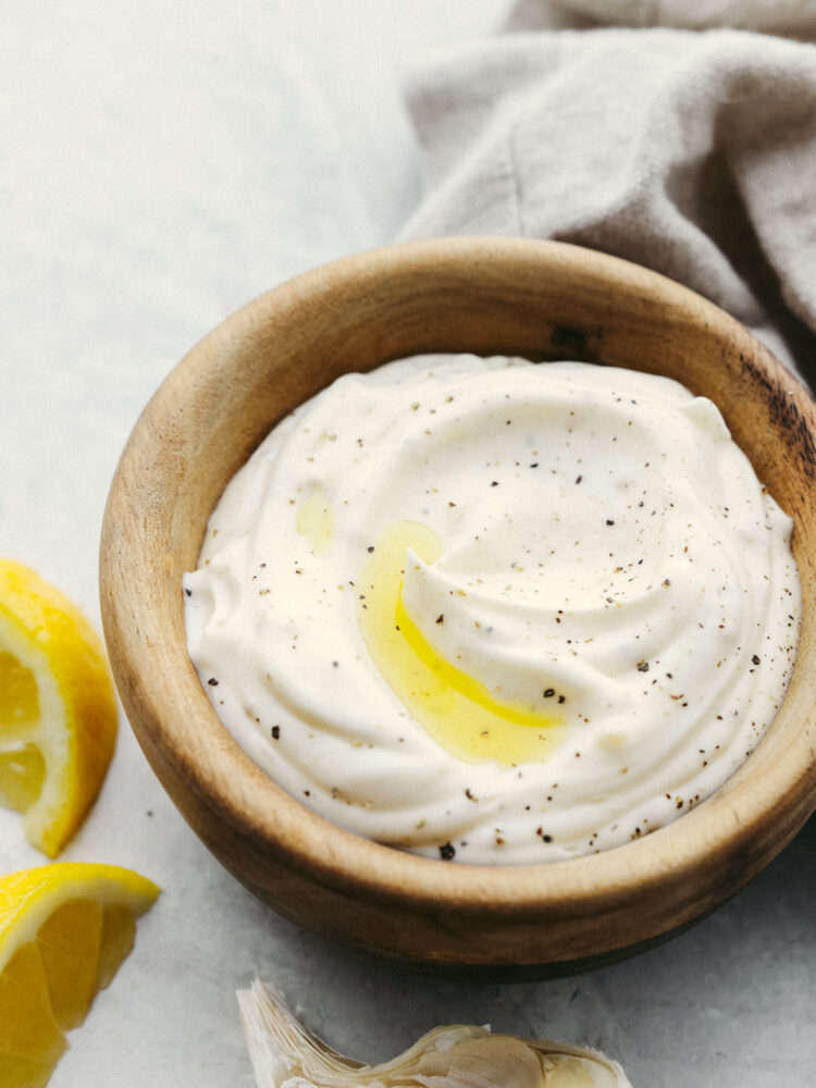 Garlic aioli sauce in a little wooden serving bowl. 