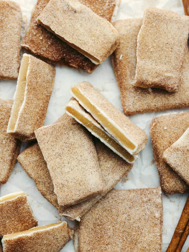 The top view of churro toffee in broken pieces on parchment paper. 