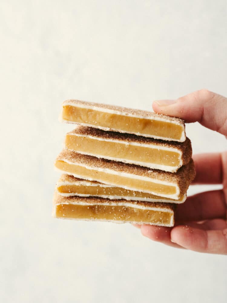 Someone holding a stack of churro toffee. 