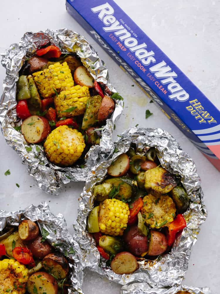 Top view of 2 Reynolds vegetable packs with a box of Reynold foil on the right. 