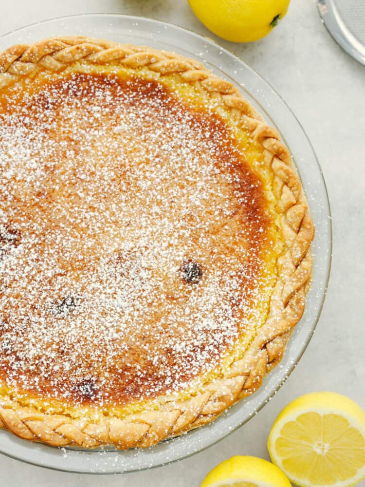 The top view of a lemon chess lie sprinkled with powdered sugar.