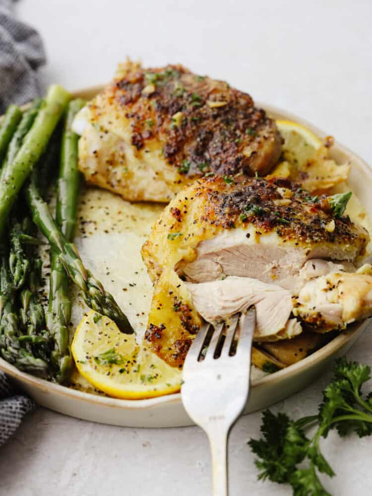 Taking a bite of chicken with a fork.