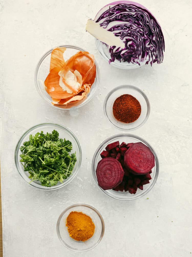 Vegetables and spices in various glass bowls, to be used as dye.