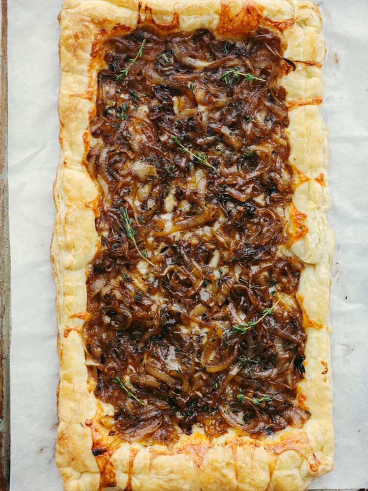 The top view of a fully cooked onion tart, just out of the oven. 