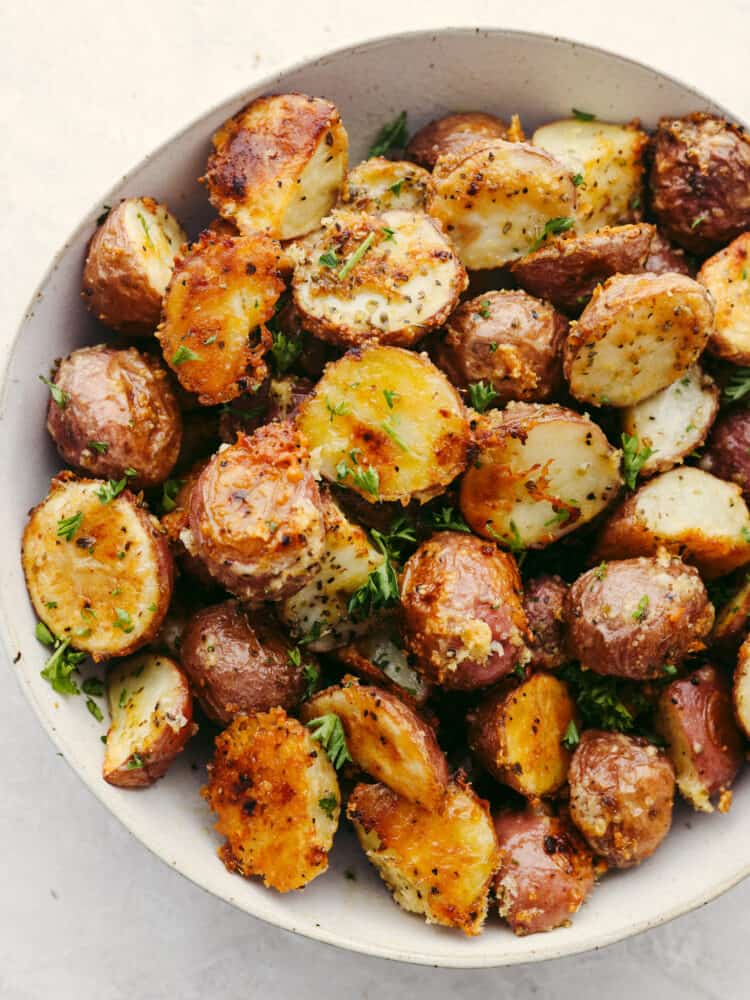 Parmesan garlic potatoes in a white bowl.