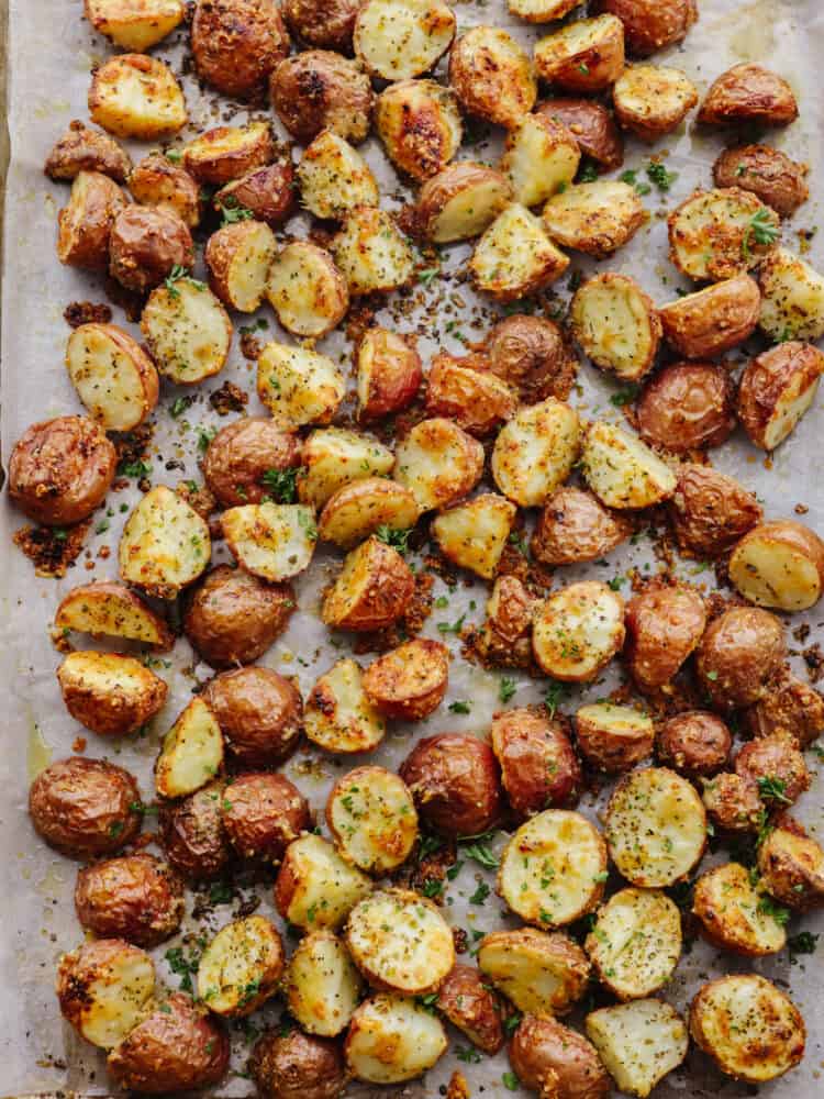 Roasted parmesan garlic potatoes on a baking sheet.