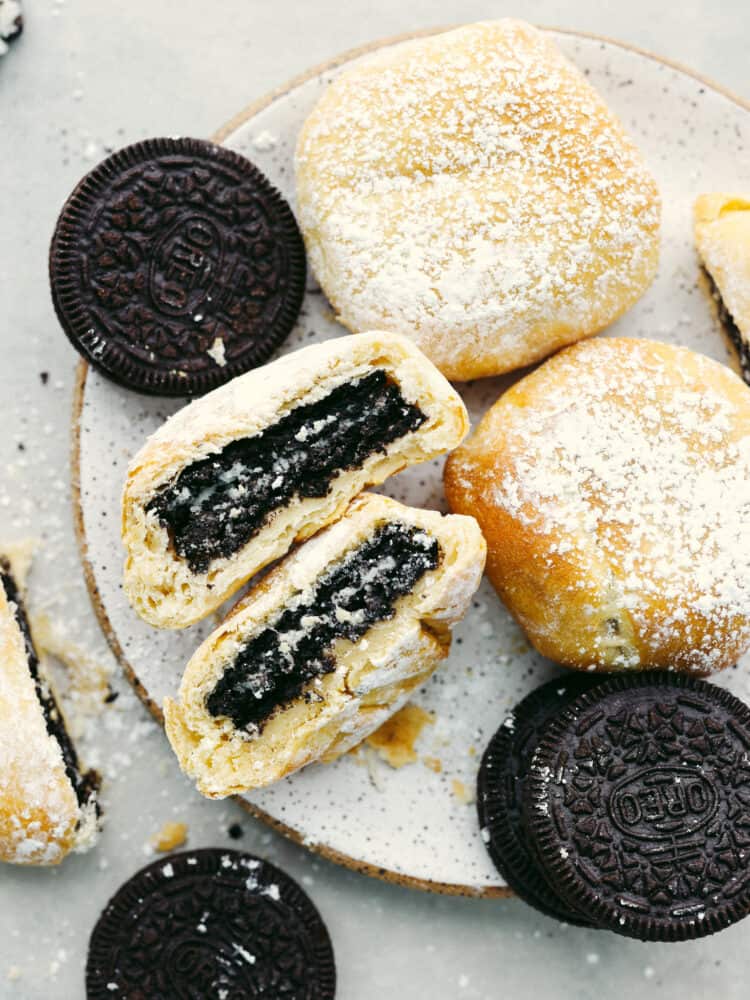 Top-down view of fried Oreos on a stoneware plate.