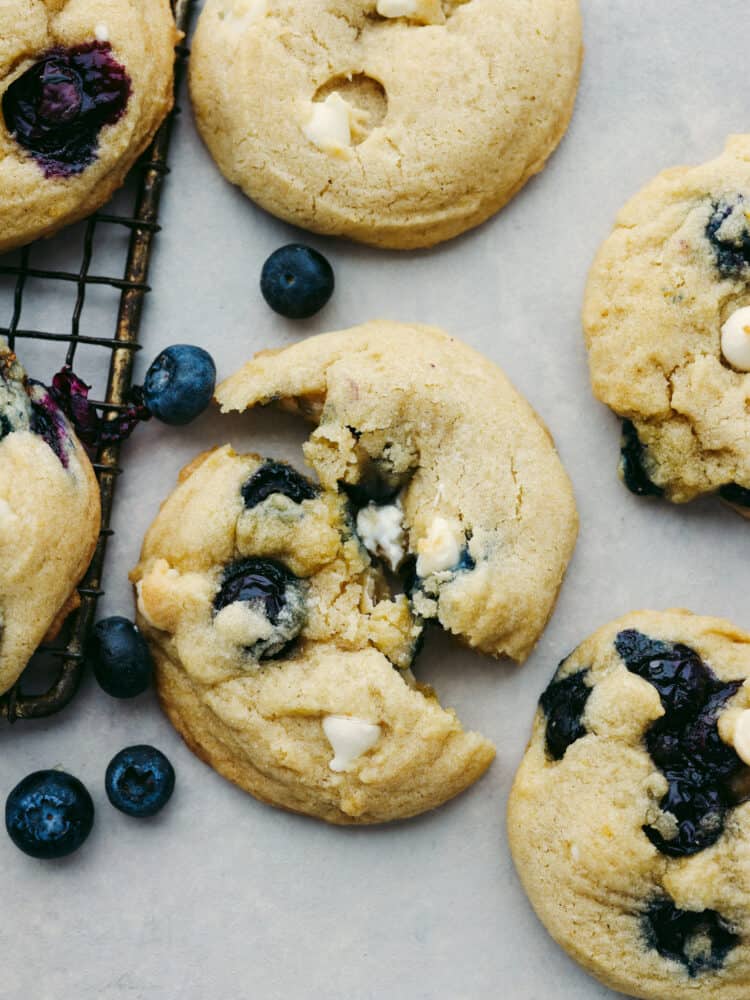 Closeup of a blueberry white chocolate cookie, broken in half.