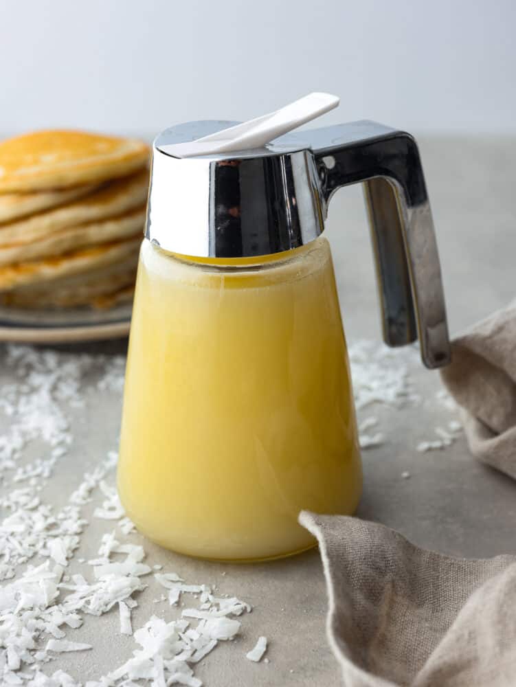 Coconut syrup in a syrup pitcher.