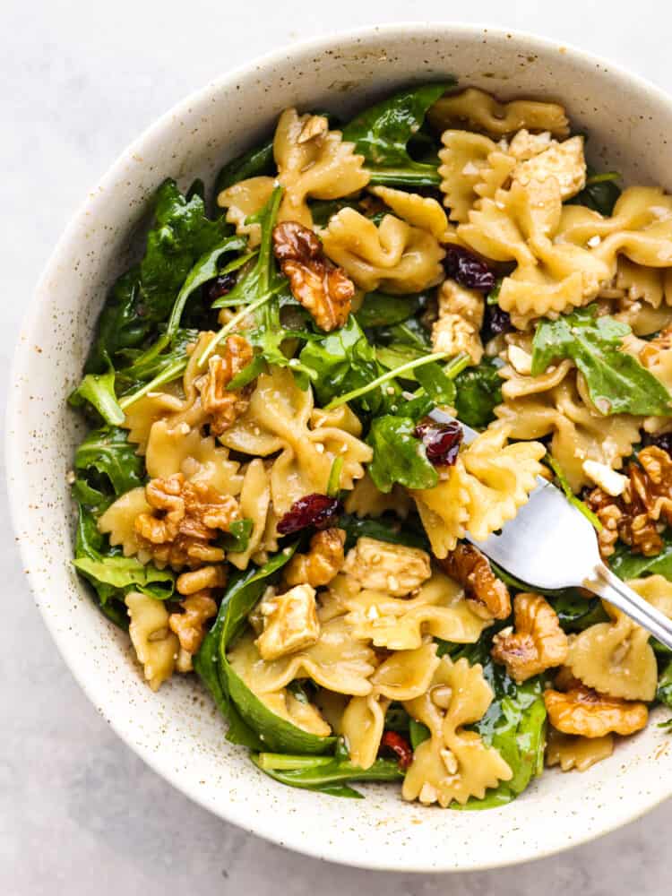 Pasta salad in a stoneware bowl, ready to eat.